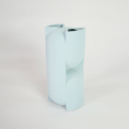 Pastel blue sculptural ceramic vase for stylish console table placement and contemporary indoor decor styling.