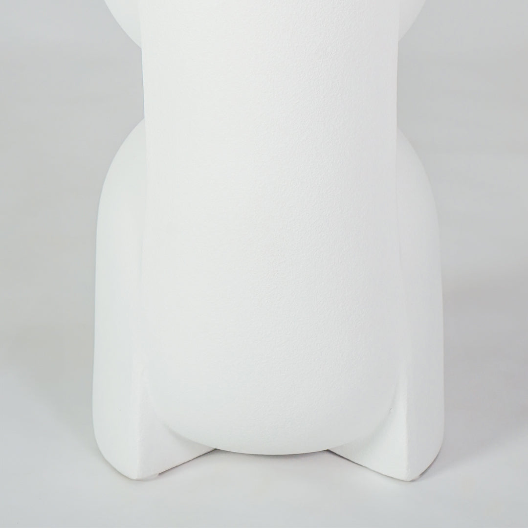 Closeup image of white ceramic modern vase for elegant shelf placement with artistic matte finish styling display.