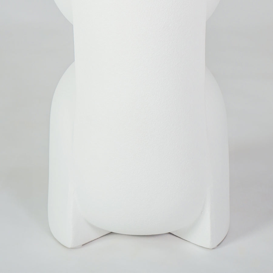 Closeup image of white ceramic modern vase for elegant shelf placement with artistic matte finish styling display.