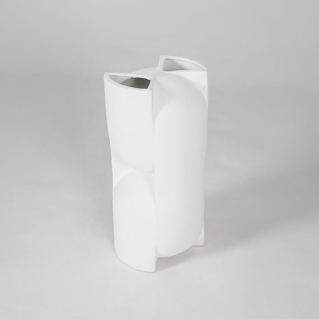 White sculptural ceramic vase for modern shelf placement and elegant indoor home decor styling accent piece.