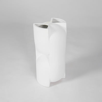 White sculptural ceramic vase for modern shelf placement and elegant indoor home decor styling accent piece.