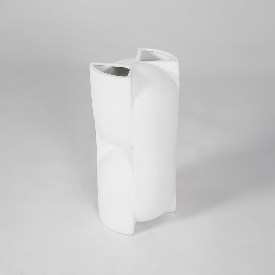 White sculptural ceramic vase for modern shelf placement and elegant indoor home decor styling accent piece.