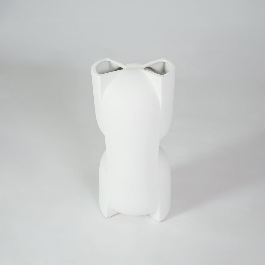 White ceramic vase for minimalist coffee table placement and modern living room decor styling accent piece.