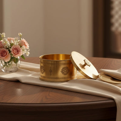 Gold metal decorative storage box lifestyle image with floral accents for elegant luxury dining table decor.