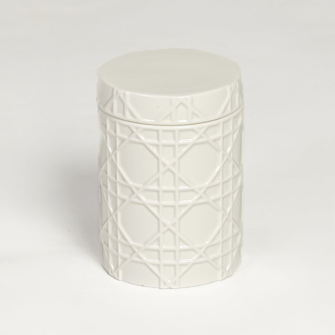 White ceramic decorative jar with embossed geometric pattern isolated on clean white background for elegant tabletop decor display.