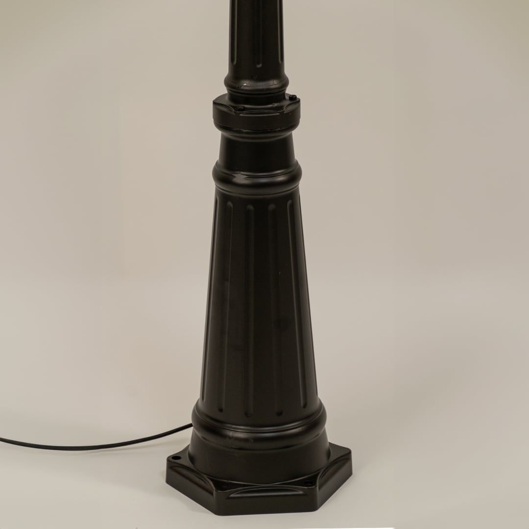 Closeup of black outdoor street lamp base with elegant metal finish for luxury exterior decor use.