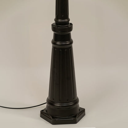 Closeup of black outdoor street lamp base with elegant metal finish for luxury exterior decor use.