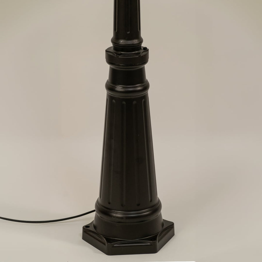 Closeup of black outdoor street lamp base with elegant metal finish for luxury exterior decor use.