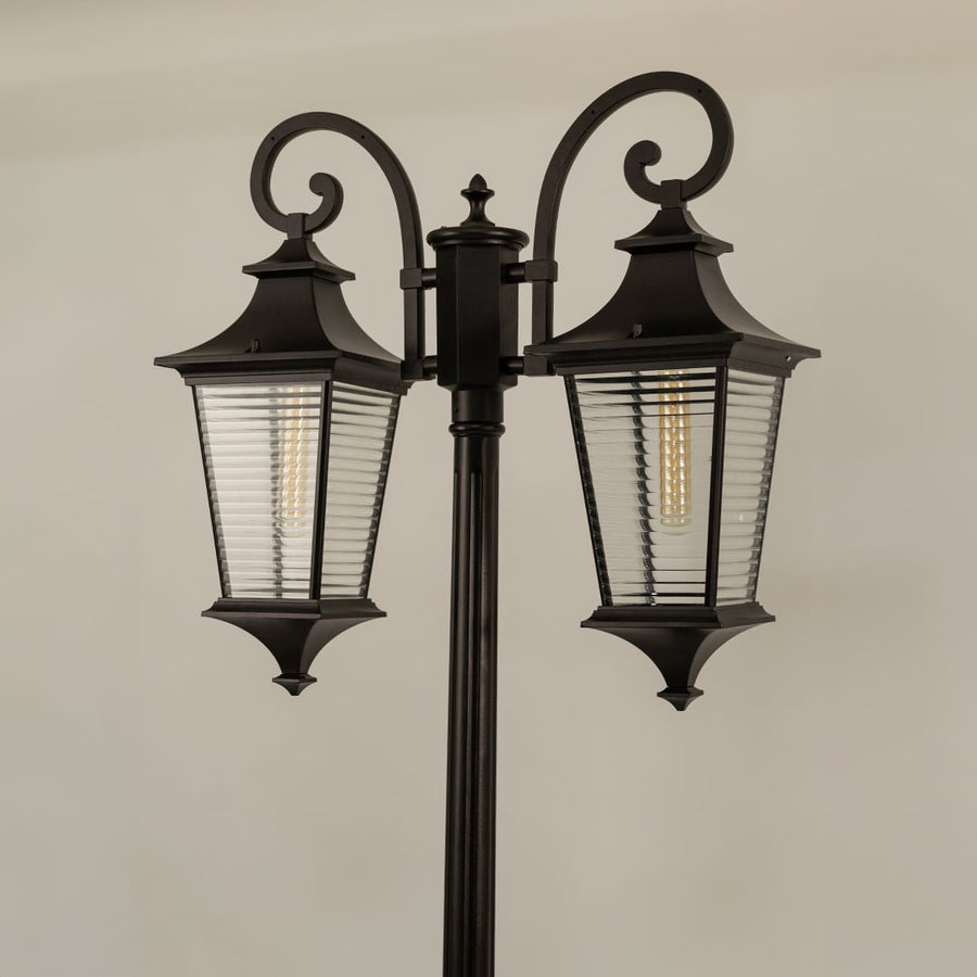 Closeup of vintage outdoor street lamp with dual ribbed lantern shades for luxury exterior decor use.