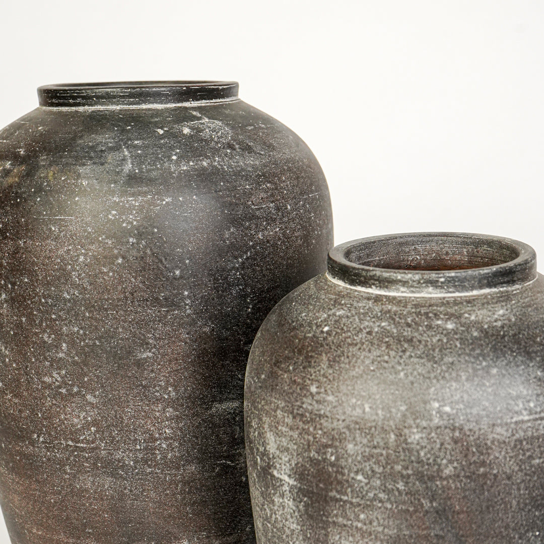 Closeup image of grey ceramic vase set for modern interior decor styling with rustic textured finish.