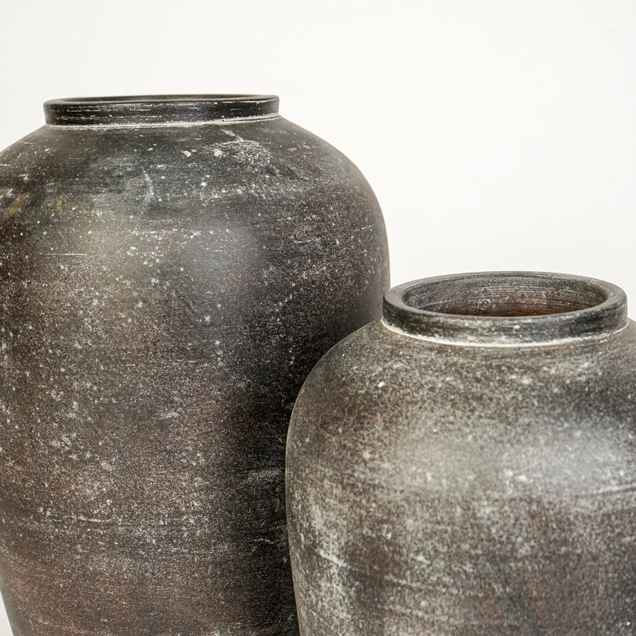 Closeup image of grey ceramic vase set for modern interior decor styling with rustic textured finish.
