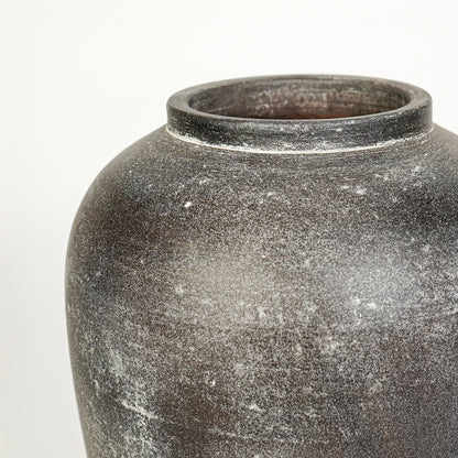 Closeup image of grey ceramic rustic vase for modern interior decor styling with textured matte finish.