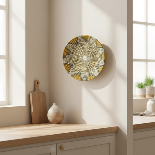 Decorative round metal wall art in gold grey tones mounted near window adding soft natural light effect and refined home decor style.
