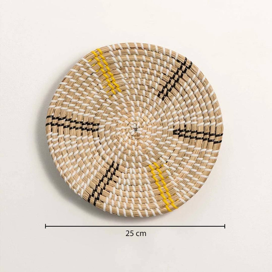Dimension image of handcrafted natural cream seagrass wall basket with yellow and black striped spokes for boho wall decor.