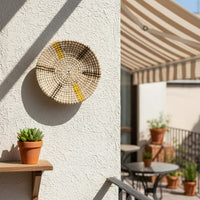 Round decorative wall plate with botanical motif styled above console shelf creating soft artistic focus with natural tones for modern home interiors.
