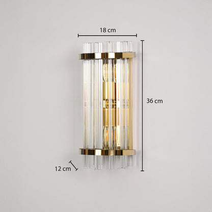 A gold crystal wall light displayed on a black background showing dimensions 18 cm width 36 cm height and 12 cm depth.