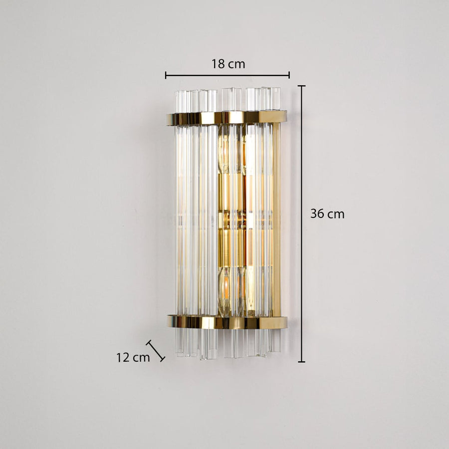 A gold crystal wall light displayed on a black background showing dimensions 18 cm width 36 cm height and 12 cm depth.