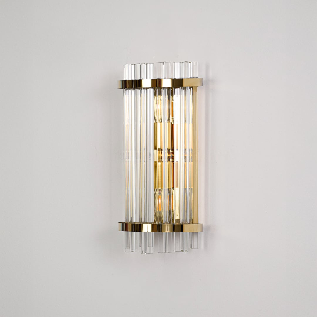 Elegant gold metal wall light switched off on dark background emphasizing sleek structure and premium glass detailing.