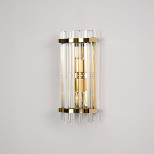 Elegant gold metal wall light switched off on dark background emphasizing sleek structure and premium glass detailing.