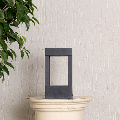 Contemporary black pillar light with open frame design shown off on clean white background for outdoor decor.