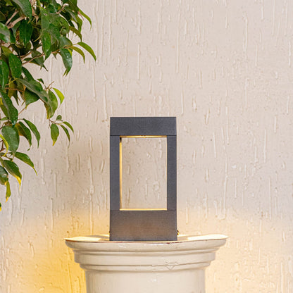 Black metal pillar light displayed on white background showcasing compact design ideal for bedside table and shelf Decor.