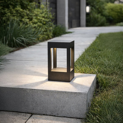 Black metal outdoor lantern light placed on concrete step for elegant exterior lighting decor styling ideas.