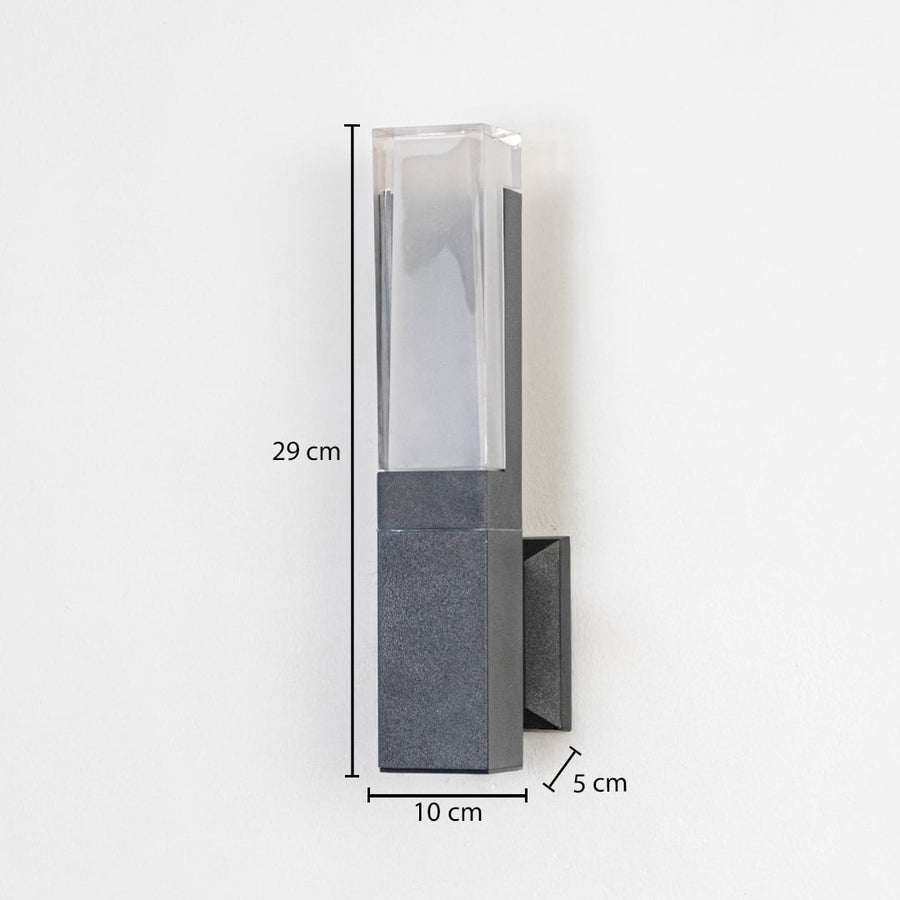 Modern outdoor wall light in metal and glass finish mounted on wall showing 29 cm height 10 cm width and 5 cm projection.