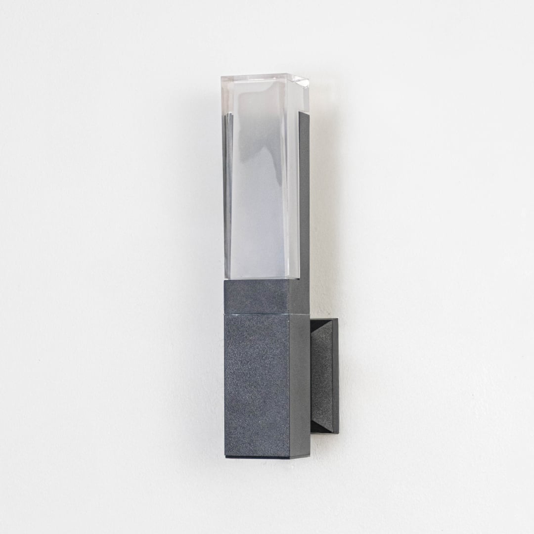 Minimal wall light with matte black frame and frosted diffuser displayed off on plain white background.