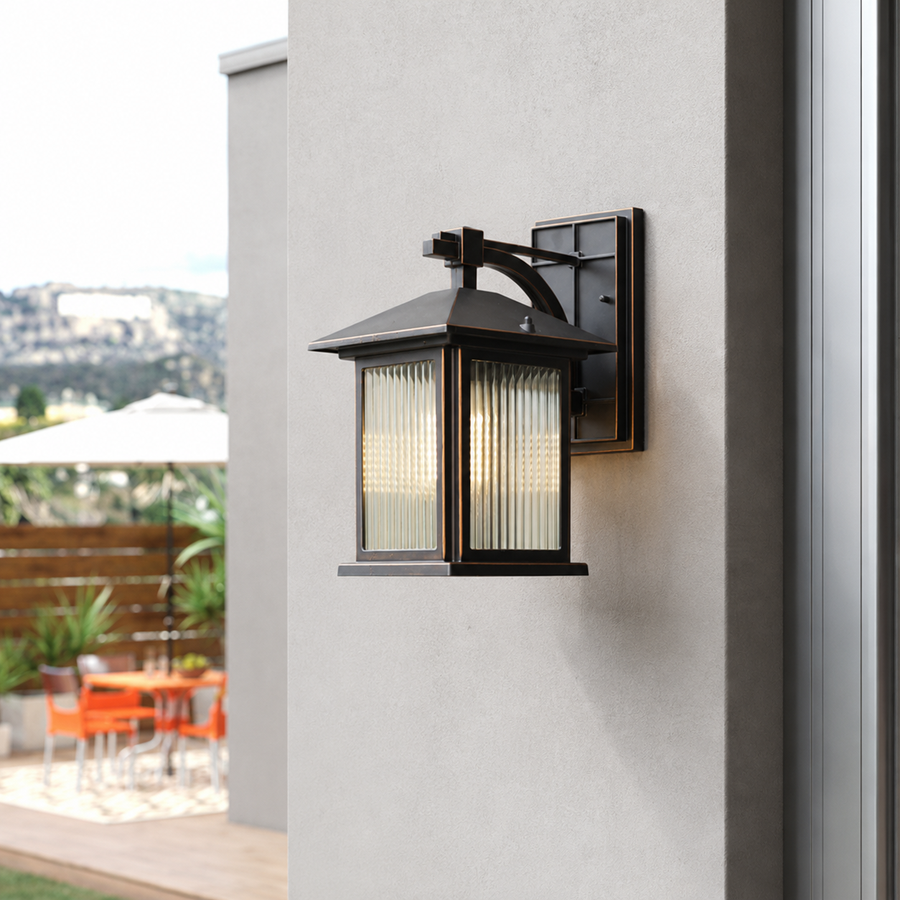 Modern black aluminum rectangular frosted glass wall lantern on white stucco facade for outdoor house patio lighting.