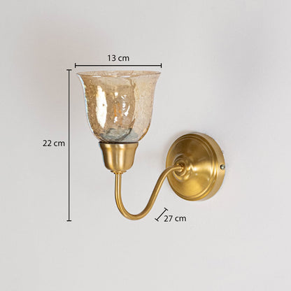Traditional brass wall lamp with amber glass shade measuring 22cm height 13cm shade width and 27cm projection from wall.