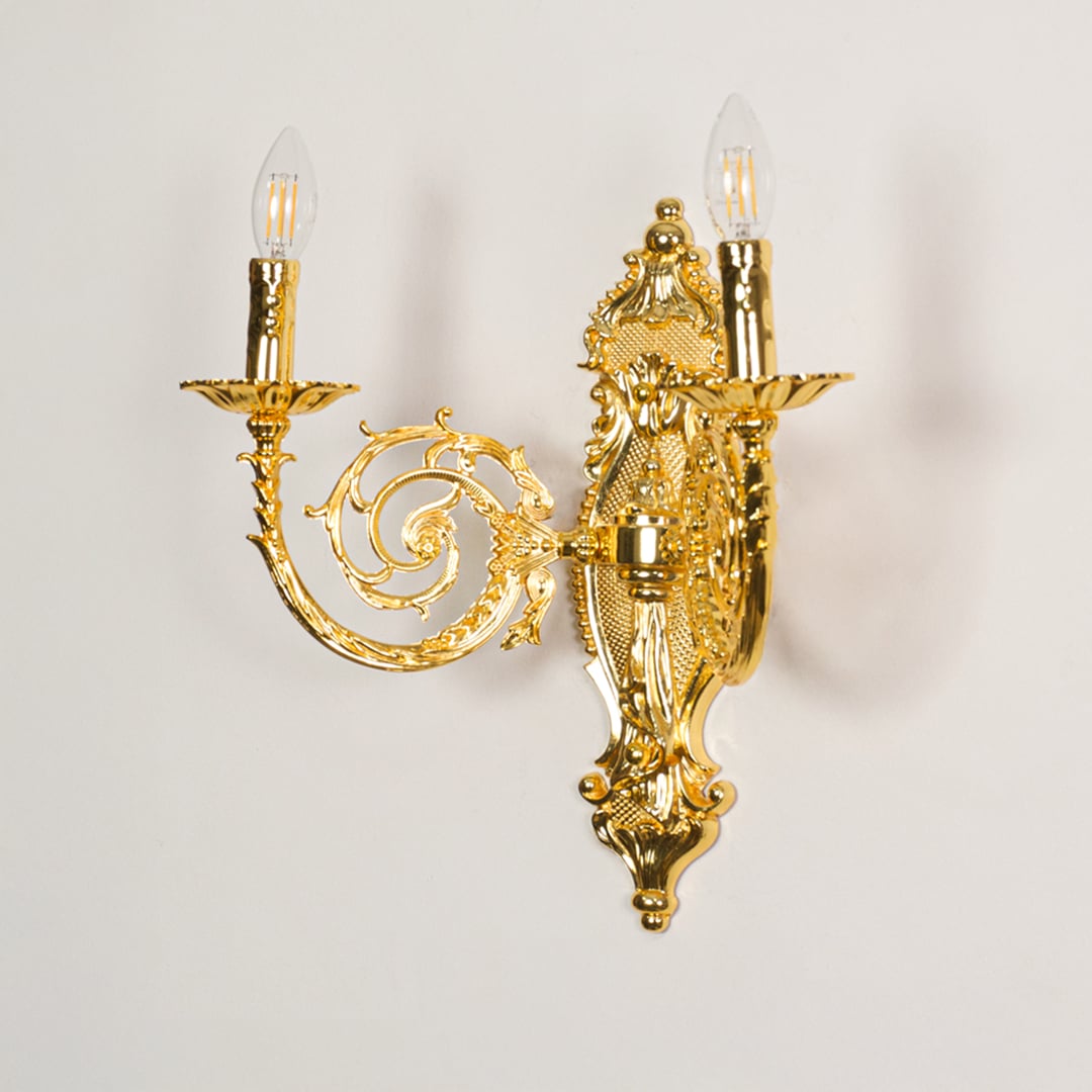 Wall light with gold metal frame and ornate carvings displayed on a white background for clear refined product detail.