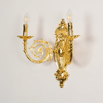 Wall light with gold metal frame and ornate carvings displayed on a white background for clear refined product detail.