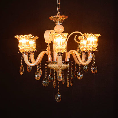 Golden glass crystal chandelier glowing warmly on black background creating a luxurious statement for modern ceilings.