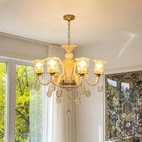 Gold crystal chandelier with sparkling crystal accents creating luxurious ambient lighting in an elegant classic living room.