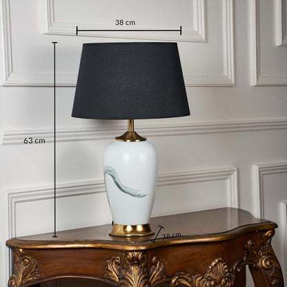 White ceramic table lamp shown with 63 cm height 38 cm shade width and 38 cm base width on a carved wooden console for accurate size reference.