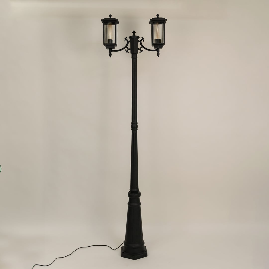 Outdoor garden post lamp with black metal body shown unlit on off white background suitable for pathway and landscape lighting.
