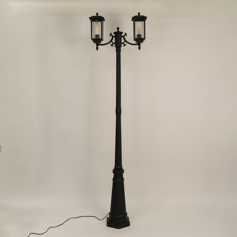 Outdoor garden post lamp with black metal body shown unlit on off white background suitable for pathway and landscape lighting.