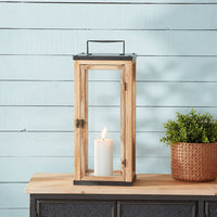 Lifestyle image of large brown wooden lantern for rustic patio decor styling and modern outdoor home garden lighting.