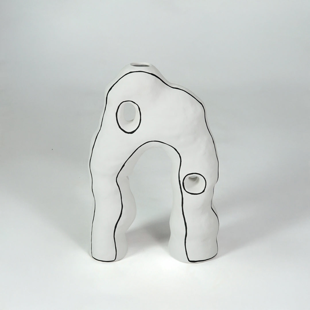 White abstract ceramic decor sculpture for modern shelf placement and artistic indoor home decor styling accent.