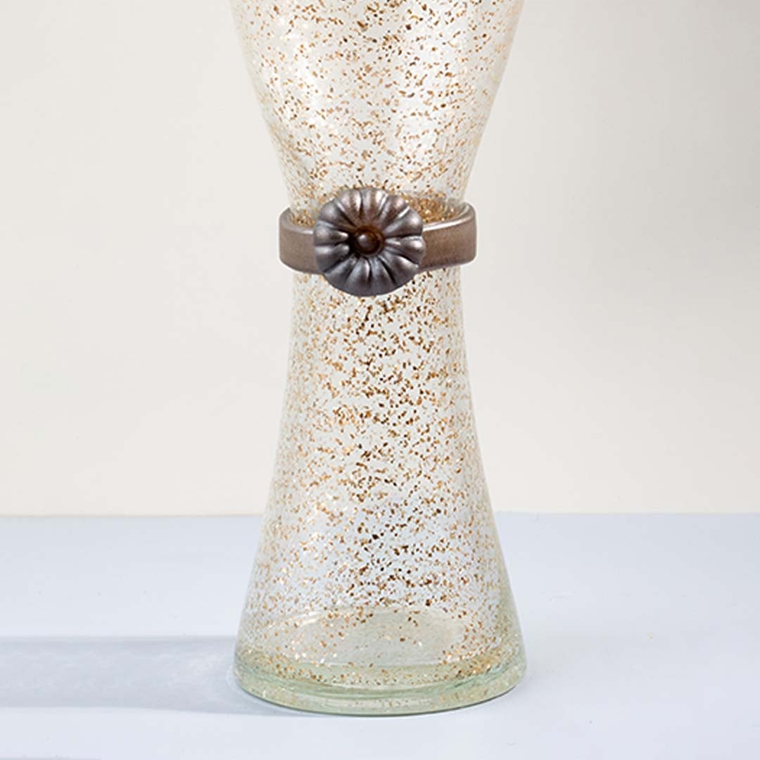 Closeup of tall golden speckled glass vase with metallic floral accent detail showing elegant craftsmanship for decor.