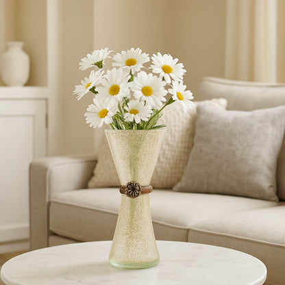 Decorative frosted glass vase with textured finish and floral accent placed on round table holding white daisy flowers for elegant living room decor.