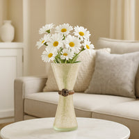 Decorative frosted glass vase with textured finish and floral accent placed on round table holding white daisy flowers for elegant living room decor.