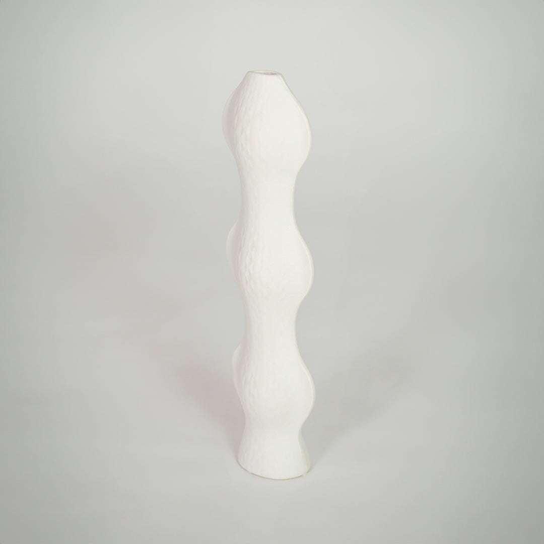 White background image of white ceramic sculptural vase for elegant shelf decor styling with textured finish.