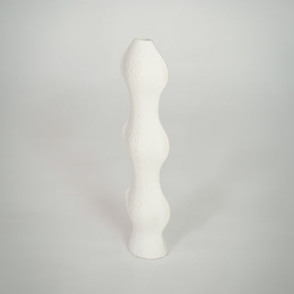 White background image of white ceramic sculptural vase for elegant shelf decor styling with textured finish.