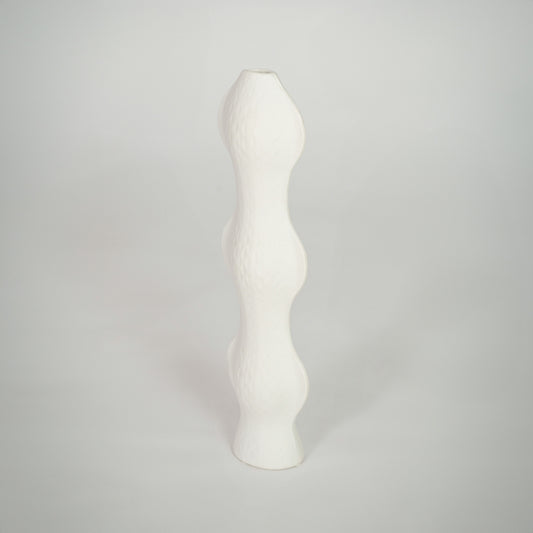 White background image of white ceramic sculptural vase for elegant shelf decor styling with textured finish.