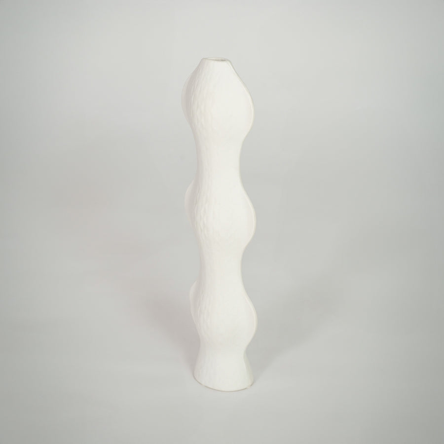 White background image of white ceramic sculptural vase for elegant shelf decor styling with textured finish.