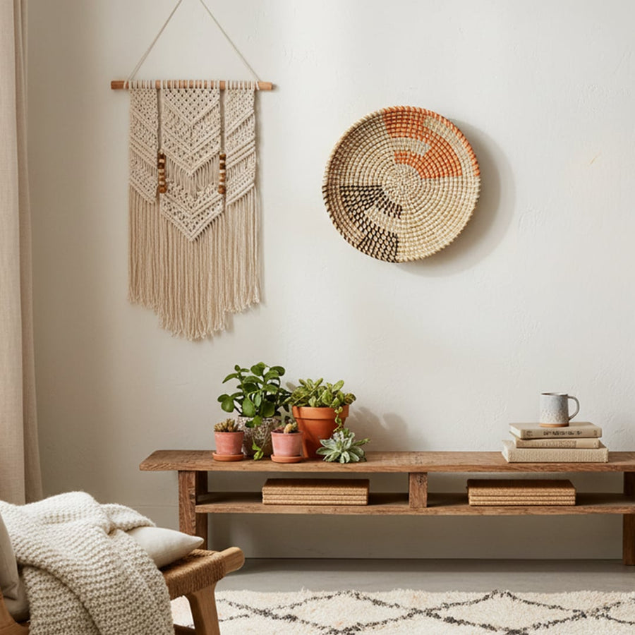 Boho round wall decor in woven natural material mounted above console table adding artisanal warmth to cozy living room interior.
