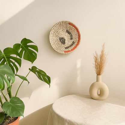 Handmade circular wall decor in natural fiber finish mounted near indoor plants adding organic texture and relaxed home styling.