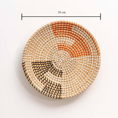Woven seagrass wall basket with orange and black pattern and dimension guide for living room and bedroom accent display.
