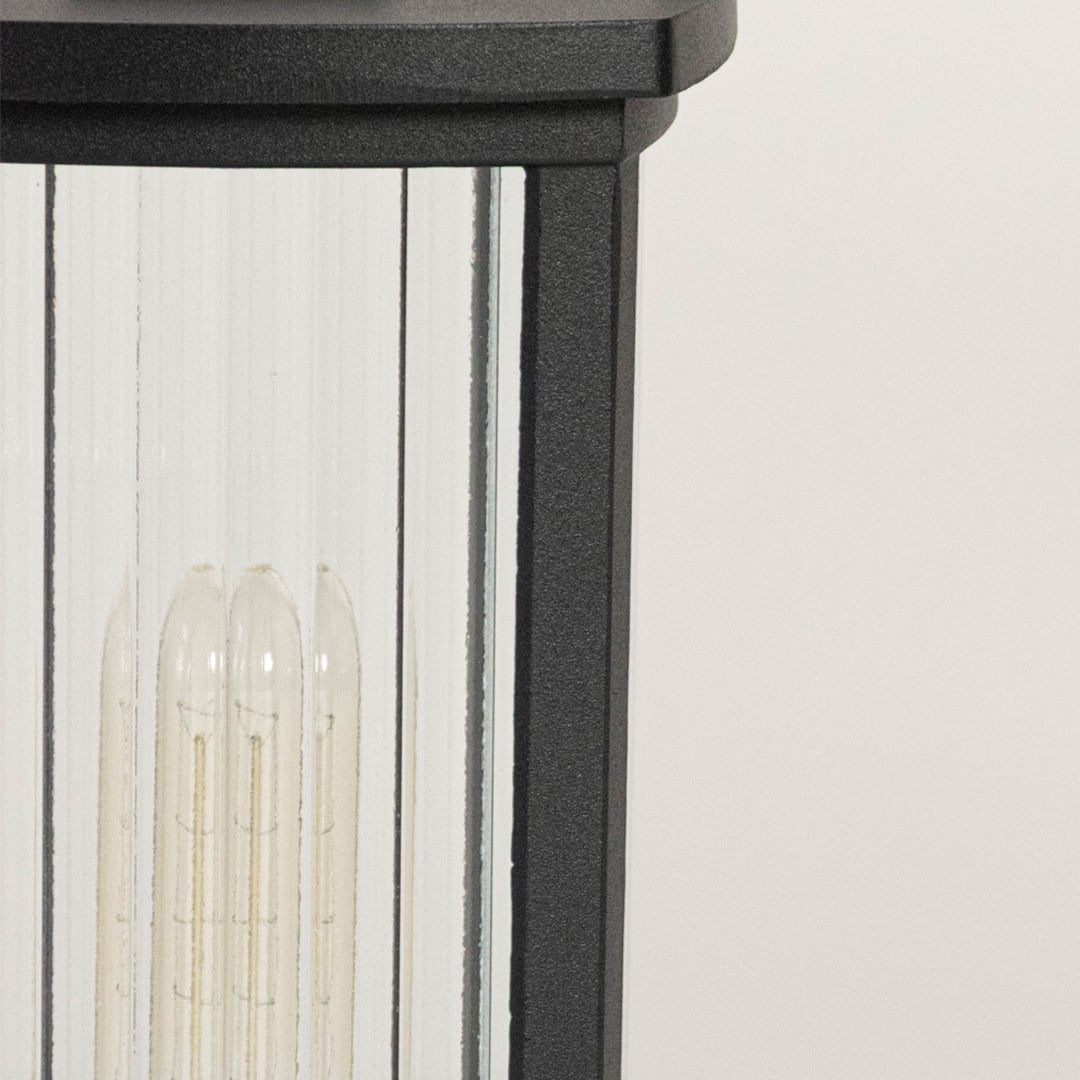 High quality LED bulb closeup inside frosted glass black pillar lamp designed for outdoor balcony and gate decor.